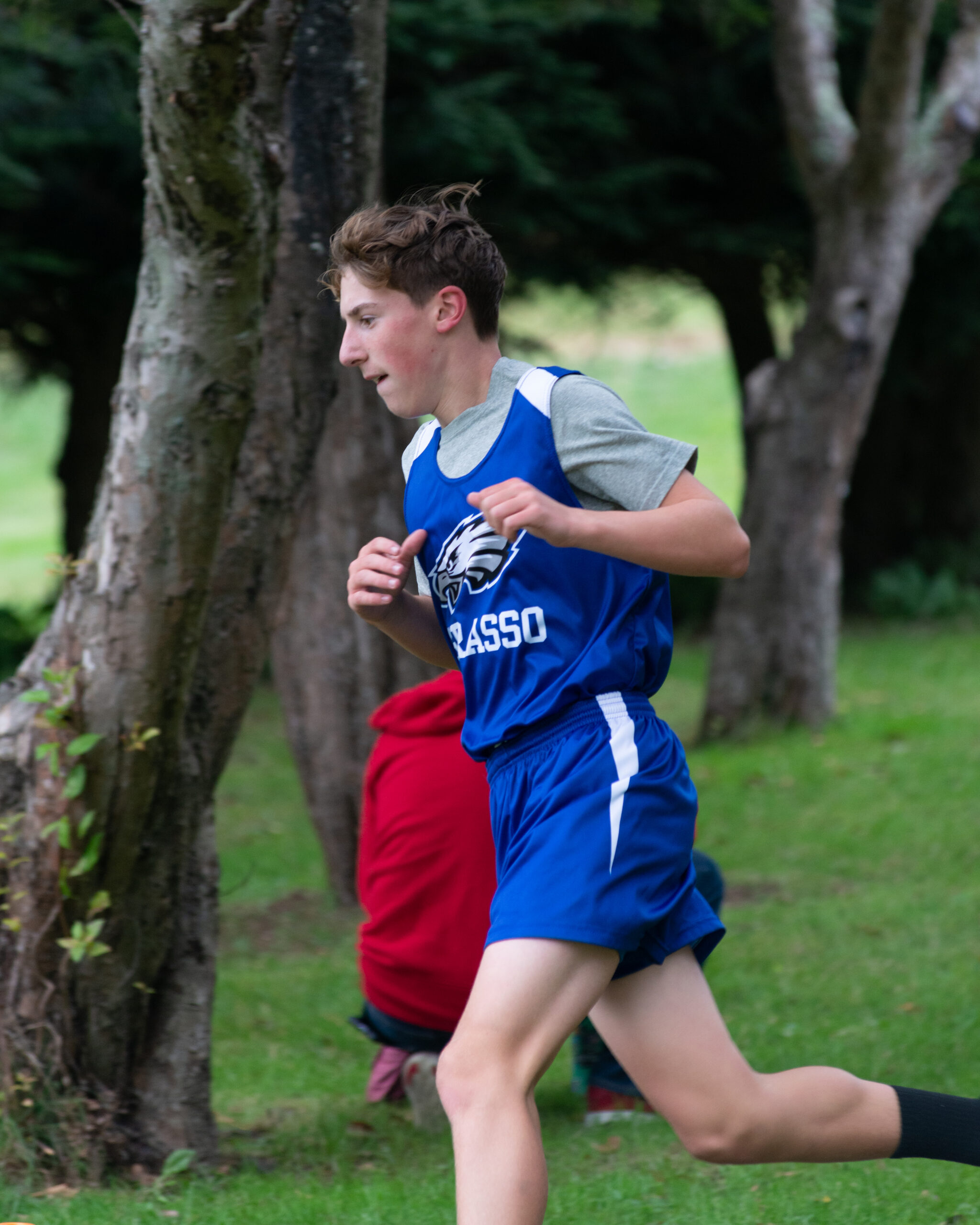 Action shot of a runner taking part in a Grasso Tech boys' Cross Country meet.